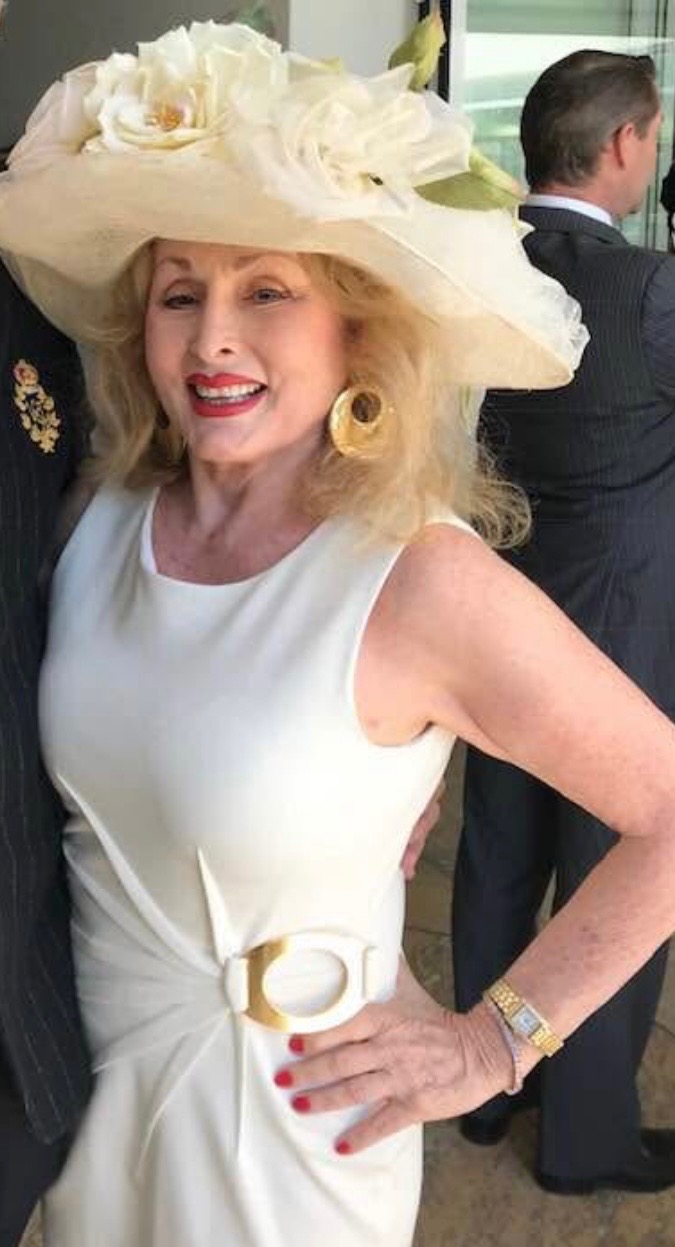 Portrait of Annette Goodman in an ivory couture hat and dress
