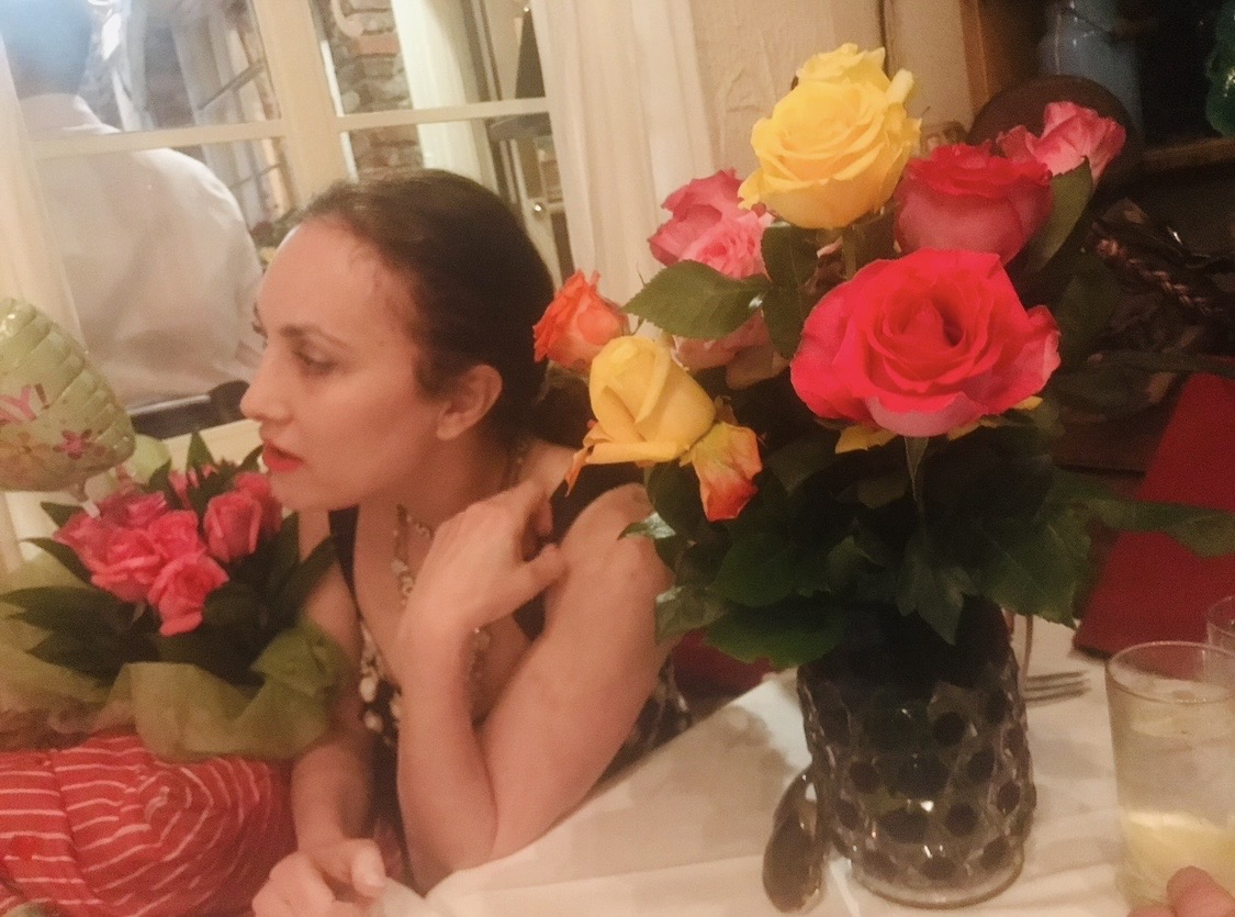 Jessica Goodman seated among vibrant roses